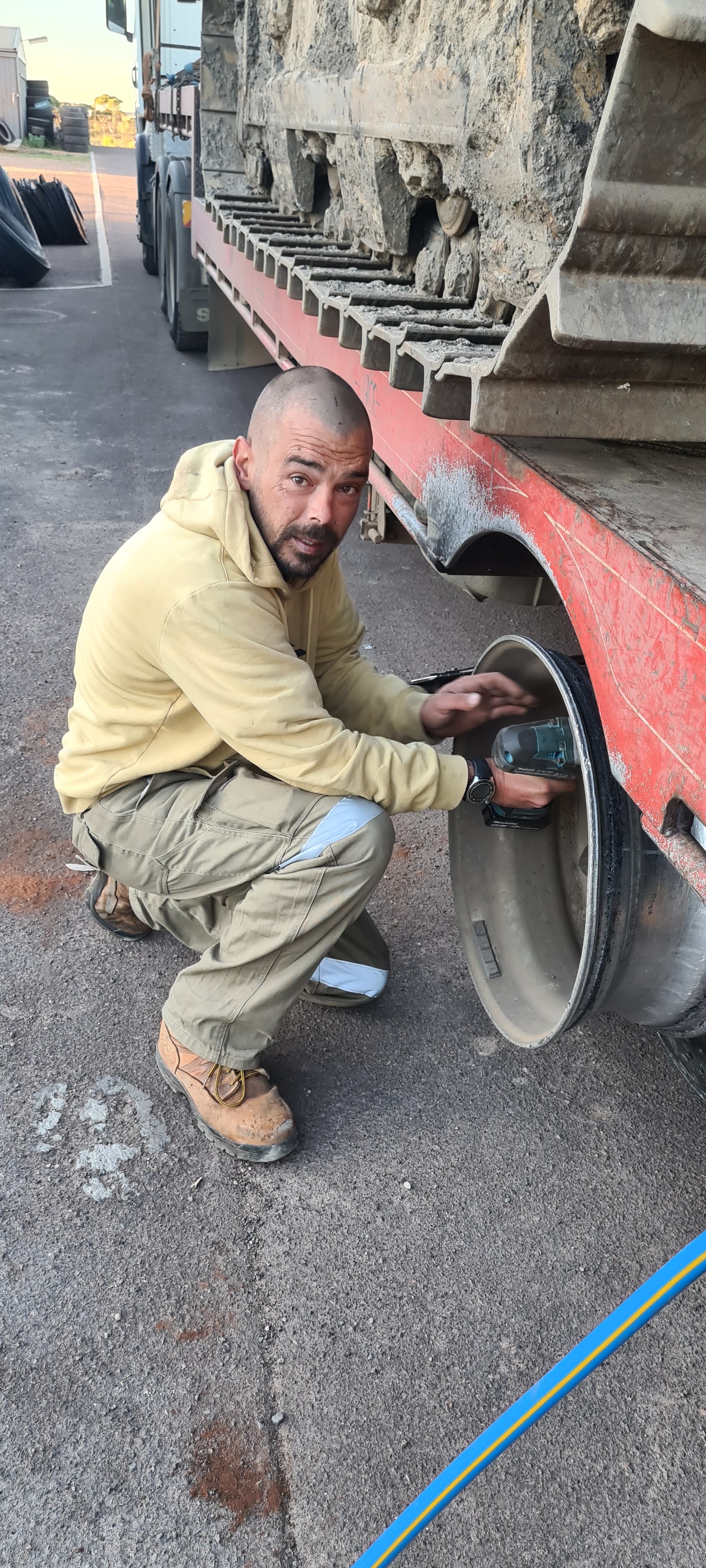 Roadside work on a low loader wheel rim
